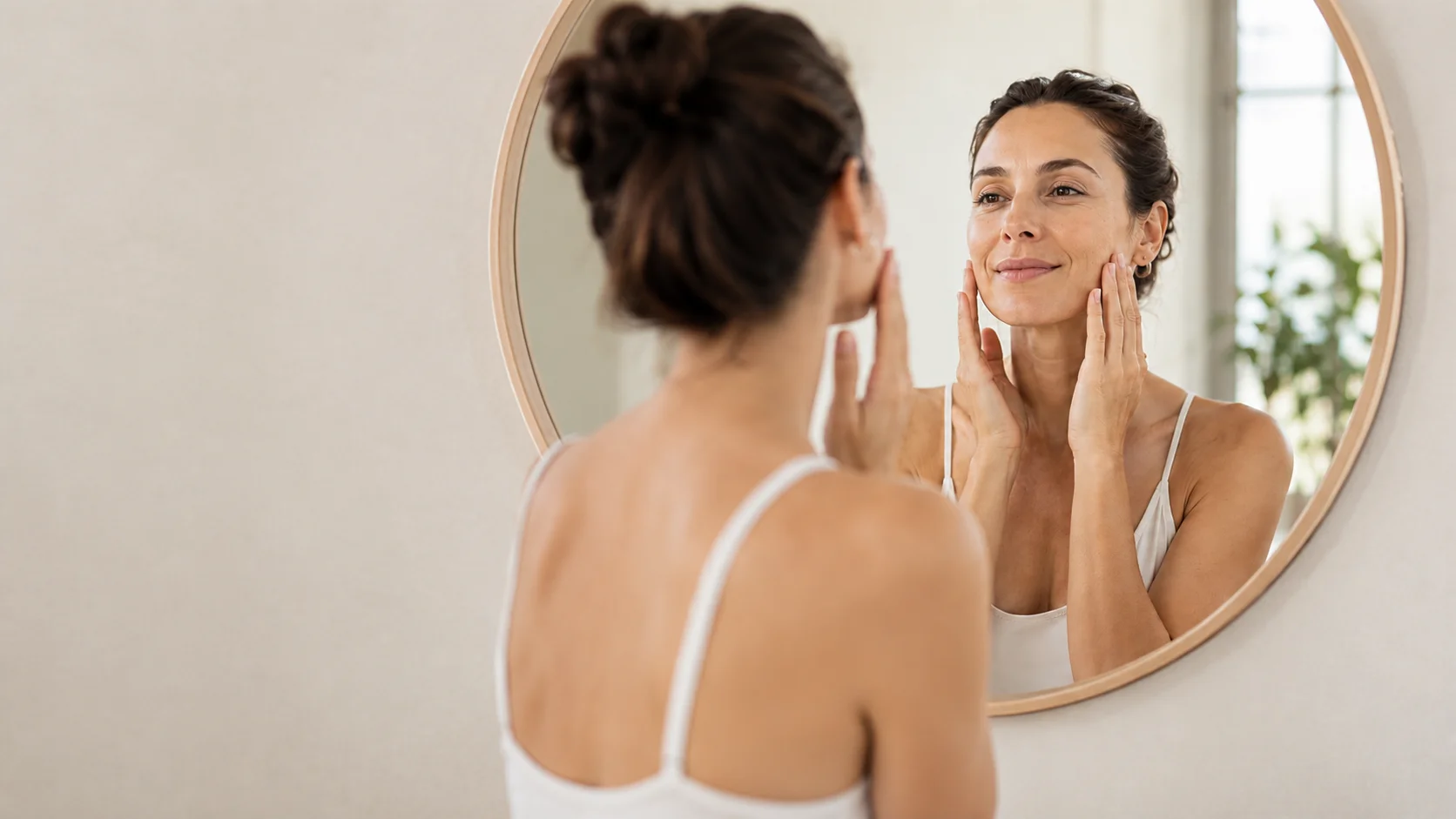 Mujer realizando una rutina de skincare frente al espejo